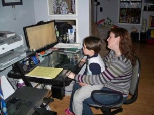 Jeannie LoVullo - photo of mom working with child in lap