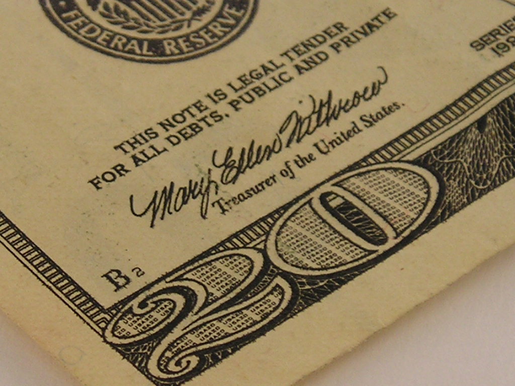 Close-up image of a corner of a U.S. twenty-dollar bill. The photo shows part of the bill’s design, including the words "This note is legal tender for all debts, public and private," and the signature of the Treasurer of the United States, Mary Ellen Withrow—a reminder that every dollar counts, especially when buying in bulk.
