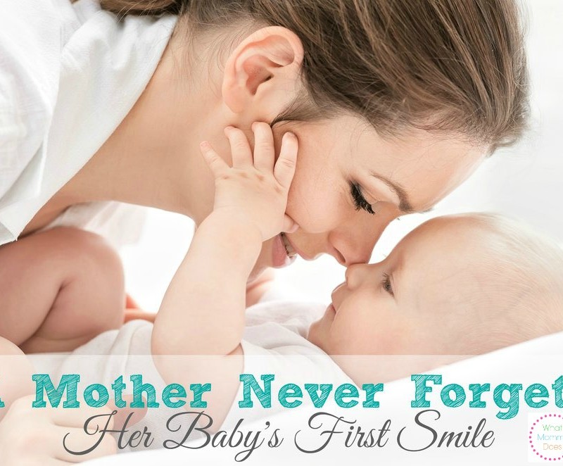 A mother gently touches her nose to her baby's face, with both looking at each other lovingly. The image contains the text "Things a Mother Never Forgets: Her Baby's First Smile" and a circular logo that says "What Mommy Does.