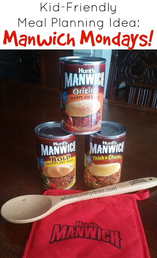 Three cans of Hunt's Manwich Sloppy Joe sauce are displayed: Bold, Original, and Thick & Chunky. They are stacked on a wooden table with a red apron labeled "Manwich" and a wooden spoon with "whatmommydoes.com" on it. Text reads: "Kid-Friendly Meal Planning Idea: Manwich Mondays!.