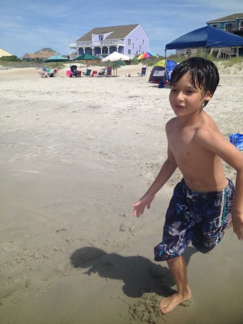 boy running in the sand