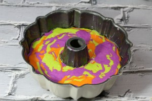 I can't bake very well, and even I was able to make this recipe! Your guests will never guess this amazing marbled Halloween bundt cake is so easy to make. I'm going to use as the feature of my Halloween party food buffet! I think it looks impressive with all the colors! | www.WhatMommyDoes.com | Category: Halloween Dessert Ideas