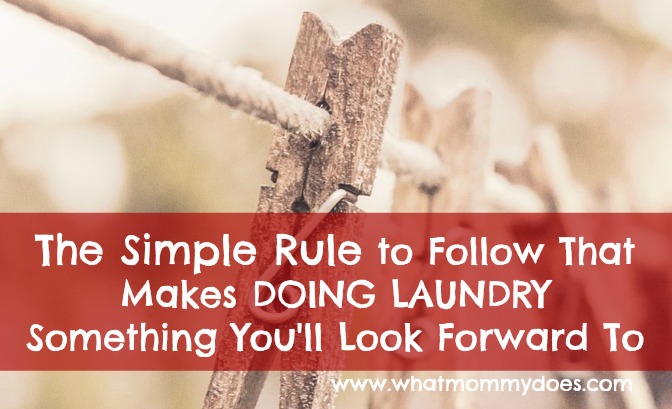 A close-up of a wooden clothespin on a clothesline with the text overlay: "The Simple Rule to Follow That Makes LAUNDRY Something You'll Look Forward To." The background is blurred, featuring more clothespins. At the bottom, a website URL is partially visible.