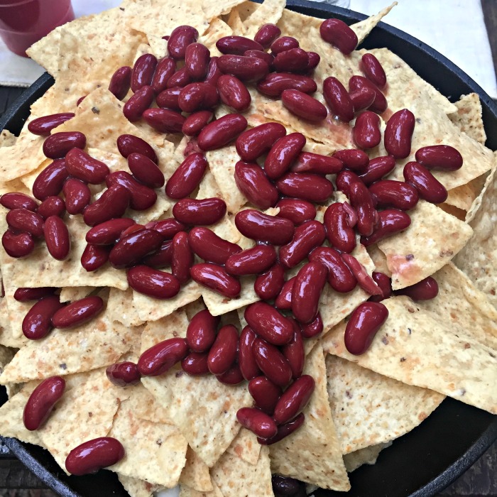 Layer the nachos with beans and cheese for a little something delicious in every bite!