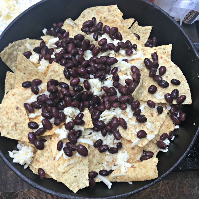 Layer the nachos with beans and cheese for a little something delicious in every bite!