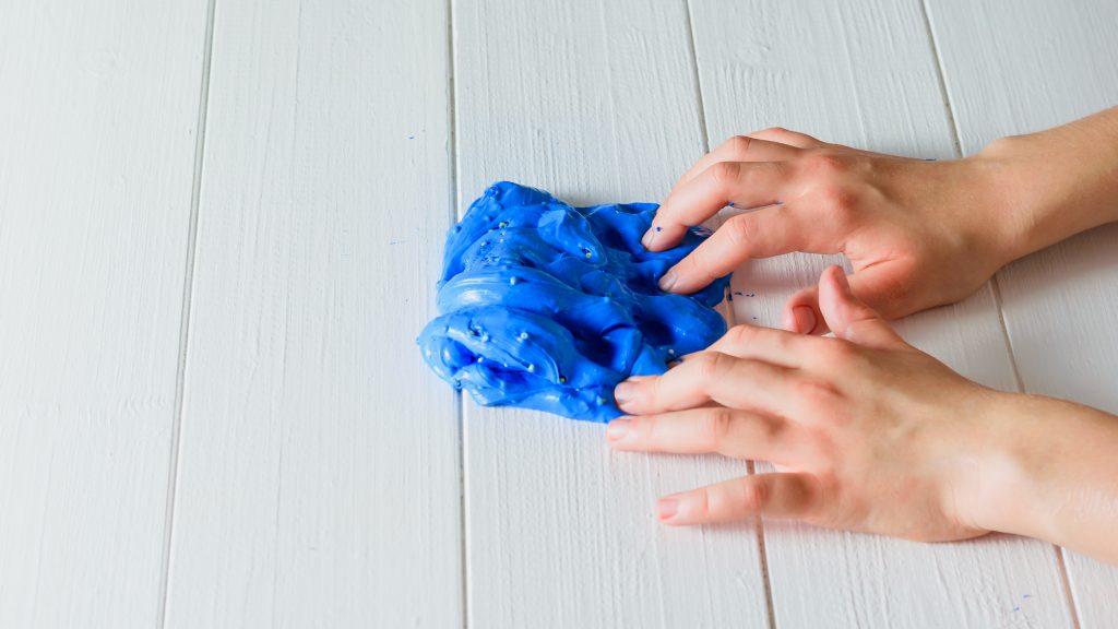 Child playing with blue lime created for school market day.