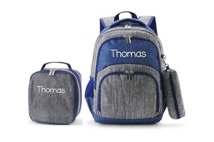 backpack and munch box matching set. Blue denim colored with the name Thomas embroidered on both. 