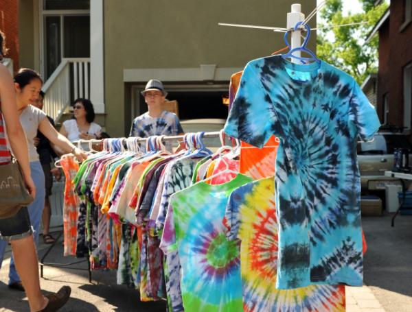 tie dye t-shirts being sold at a street fair