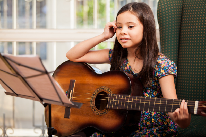 little girl taking guitar lessons as a gift