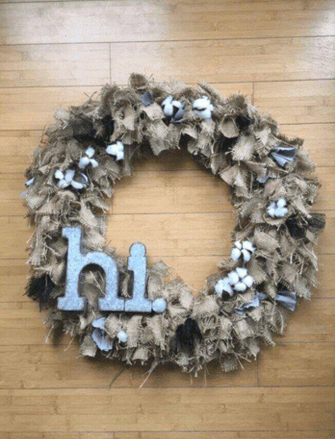 burlap shag wreath with blue letters spelling the word Hi on it