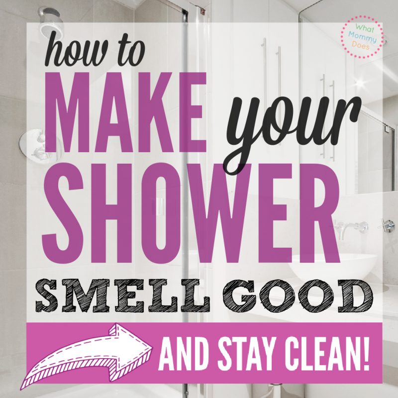 A graphic titled "How to Make Your Shower Smell Good and Stay Clean!" features a modern, white-tiled bathroom with a sleek sink and mirror in the background. The bold text is written in purple and black, accompanied by a pink, polka-dotted circular logo reading "What Mommy Does." An arrow points to the bottom of the graphic.