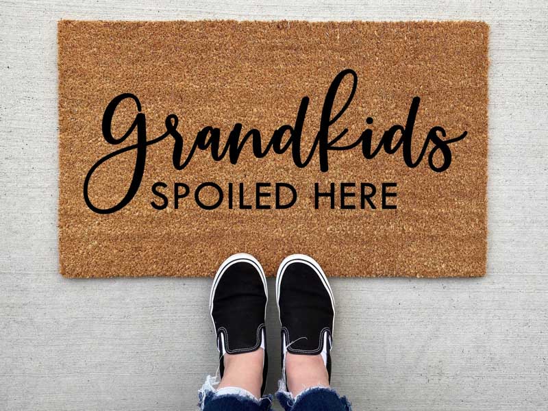 doormat that reads grandkids spoiled here