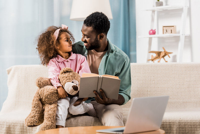 father and daughter reading from the amazon book subscription