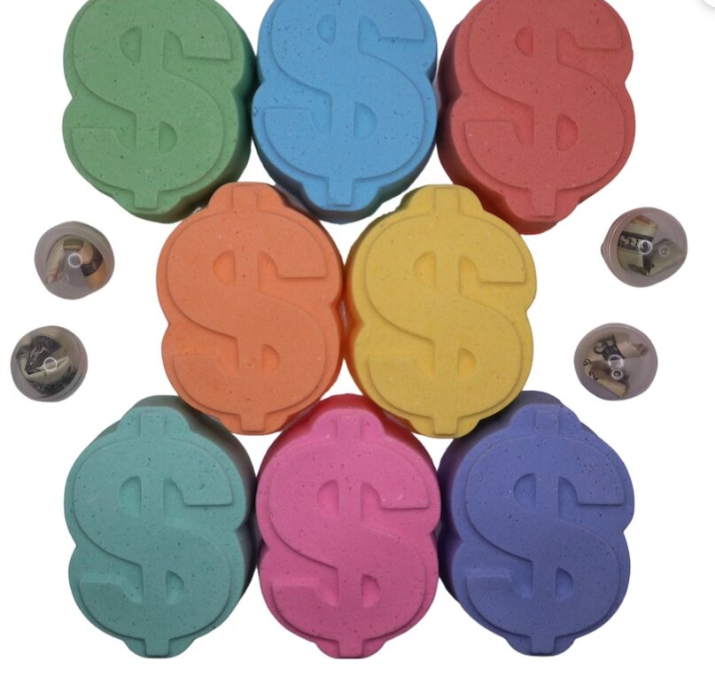 bath bombs shaped like the cash sign in various colors. 