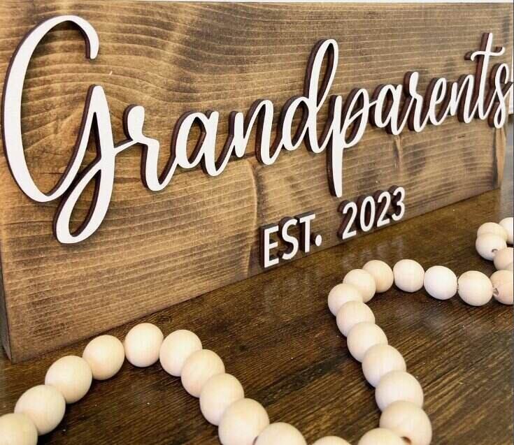 wooden sign that says grandparents est 2023