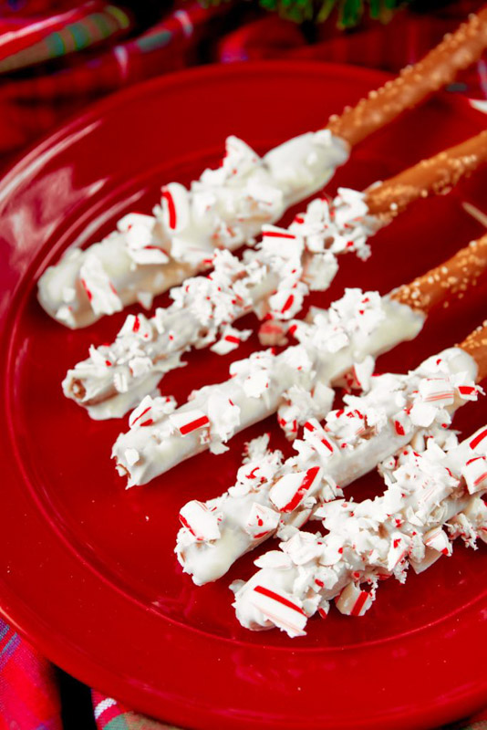 pretzel rods dipped into white chocolate coating and candy cane pieces