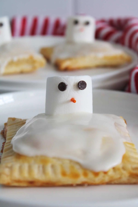 a marshmallow melted on top of a homemade pastry for a fun snowman bake sale treat