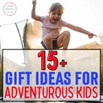 A young child is mid-jump on a trampoline with a blurred background of trees and a clear sky. The overlaid text reads "15+ Gift Ideas for Outdoorsy Kids." A small logo on the top left corner says "What Mommy Does.
