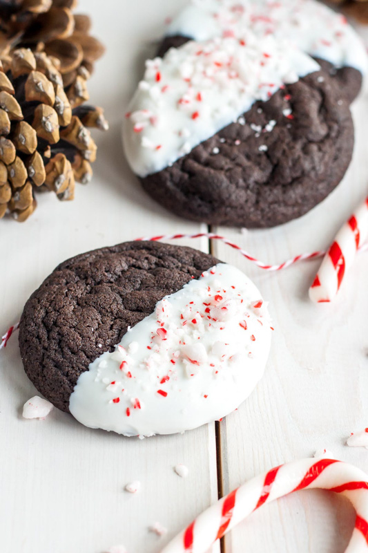 dark chocolate cookies with one half dipped in peppermint candy coating
