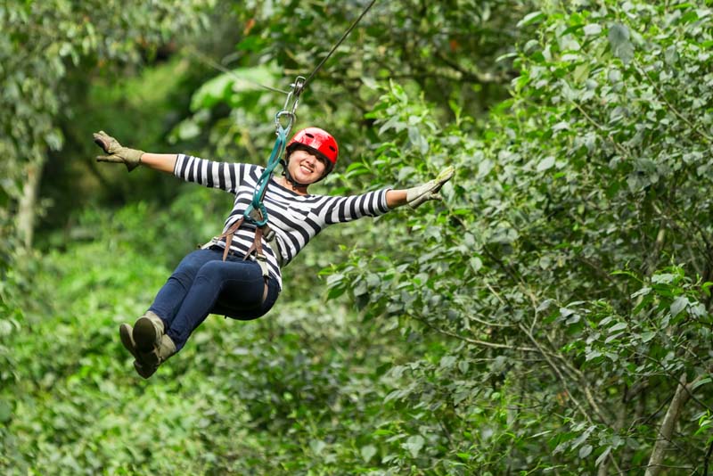 woman zip lining with family