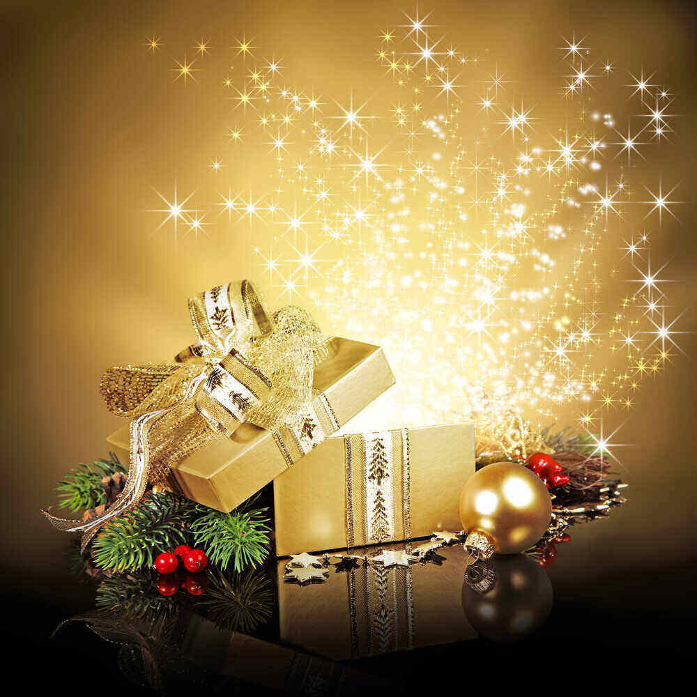 glitter an light blowing out the top of a gold gift box. Christmas themed