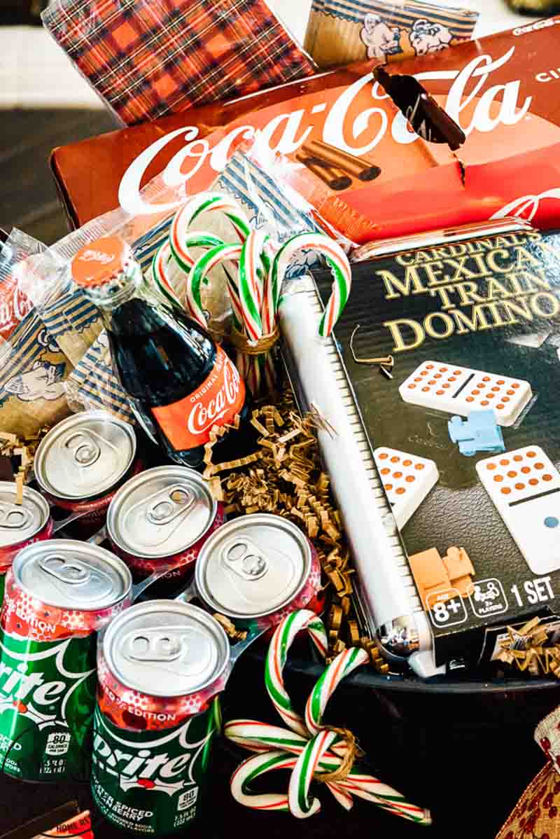 game night basket filled with sodas, candy, and dominoes