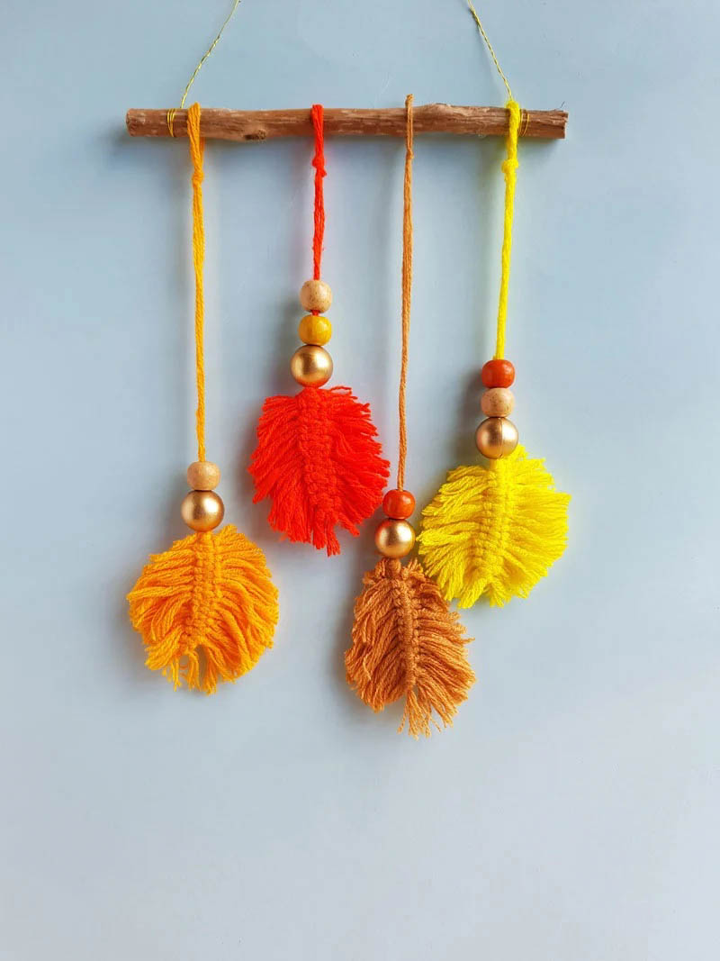 macrame fall leaf crafts hanging from a small wooden stick