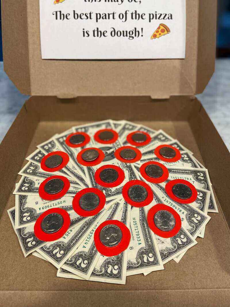 A pizza made of money using two dollar bills and quarters as the pepperoni.