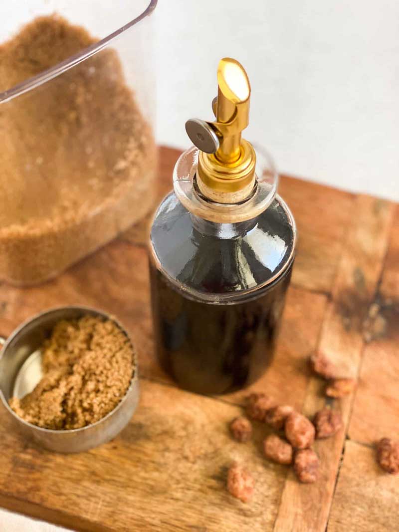 bottle of brown sugar simple syrup in a fancy bottle with golden top