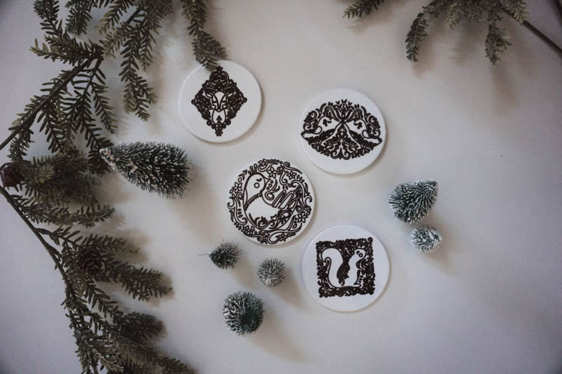 white coasters with black ink designs