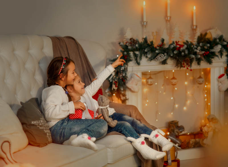 2 siblings looking at christmas decor in their house