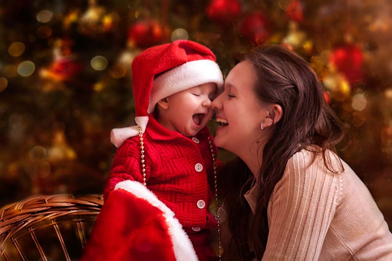 mom kissing son at christmas