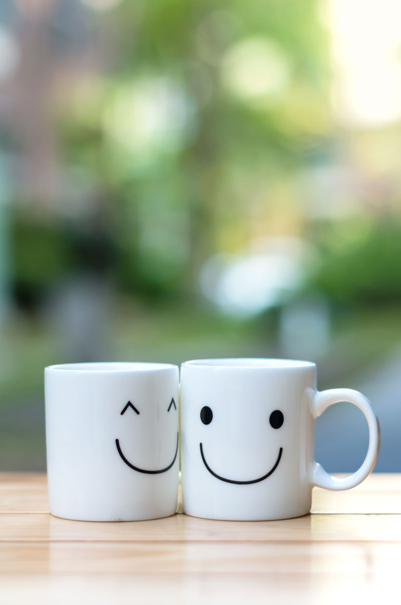 two white mugs with funny faces