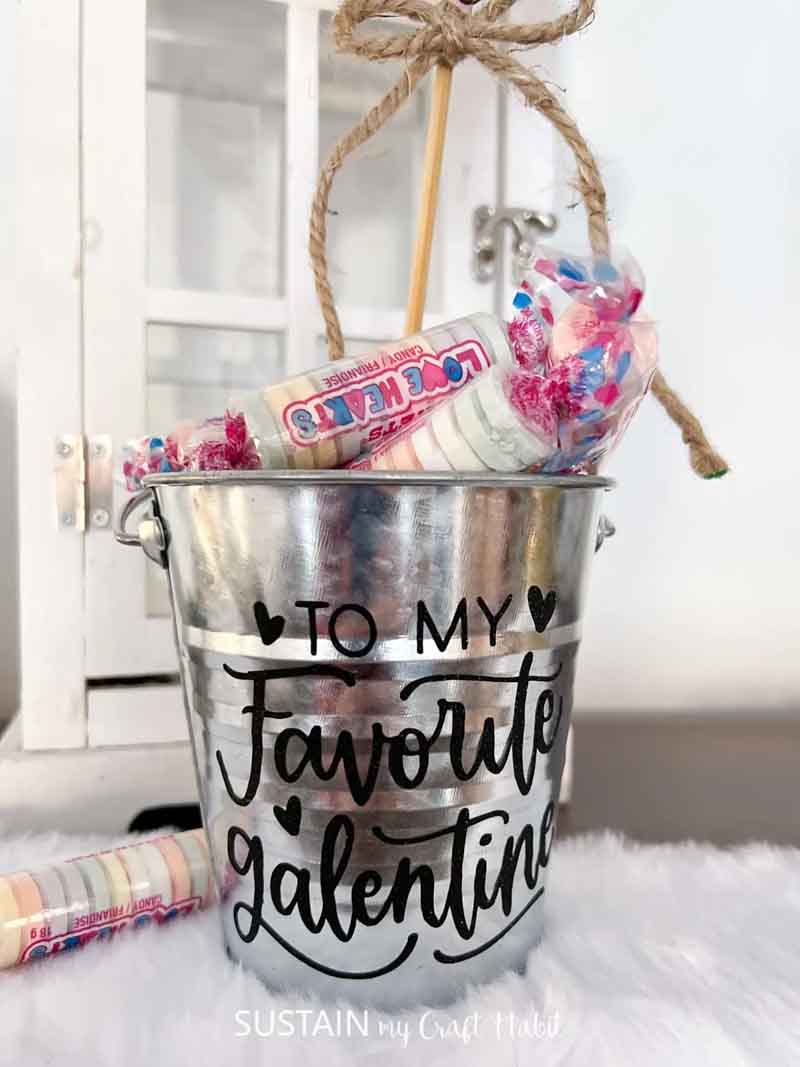 tin bucket with galentines themed letting and candy inside