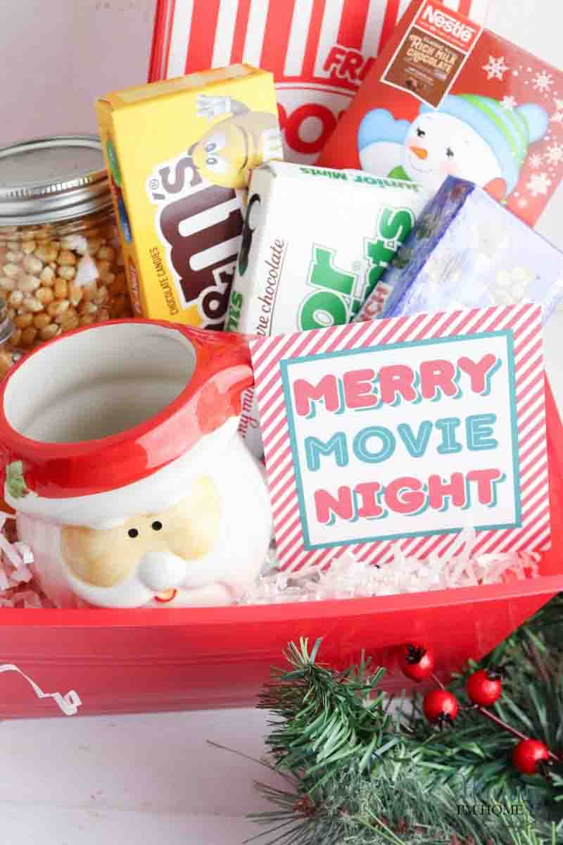 santa mug, candy, and popcorn filled gift baskets for family Christmas movie night