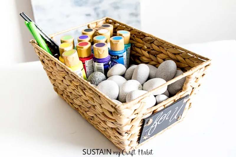 Christmas gift baskets filled with acrylic paints, brushes, and smooth rocks