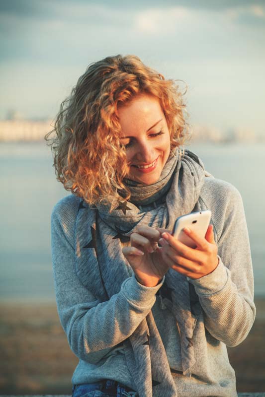 woman texting thank you for a gift