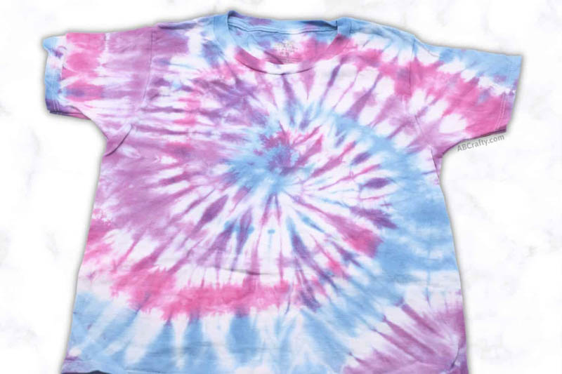 a t-shirt tie dyed in blue, pink and purple