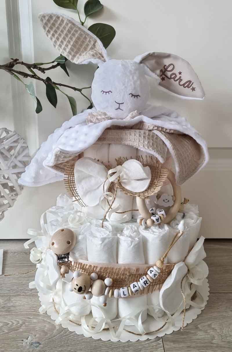 rabbit lovey on top of a diaper cake for the perfect diaper gift ideas
