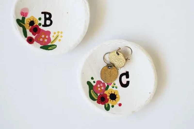 small monogrammed clay jewelry dishes on a table