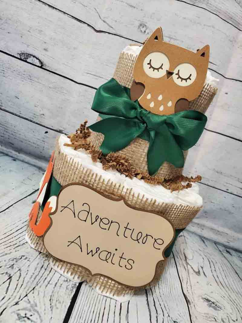 woodland baby shower decoration with a sign that says Adventure Awaits
