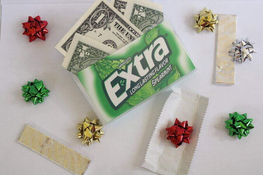 container of extra gum holding money