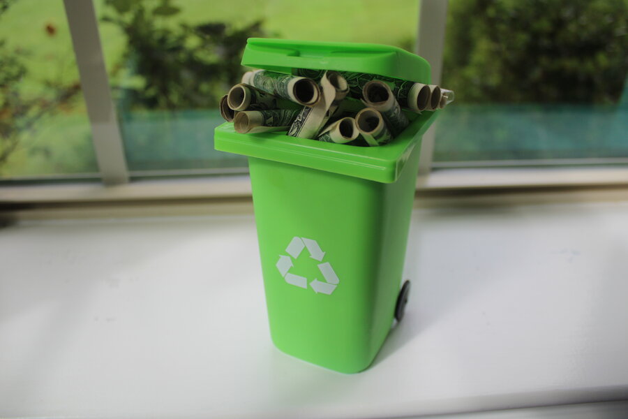 green desktop trash can recycle bin with cash in it 