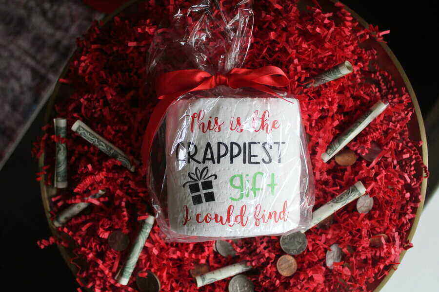 Toilet paper wrapped in clear plastic that says "This is the crappiest gift I could find."
