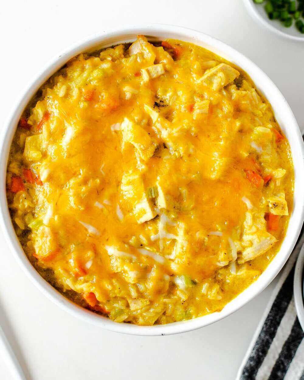 White Bowl with a cheesy curry chicken and rice. 