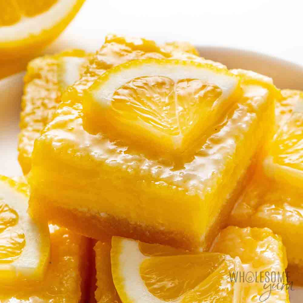 Bright and zesty keto lemon bars, a perfect choice for homemade baby shower desserts with a fresh lemon slice garnish.