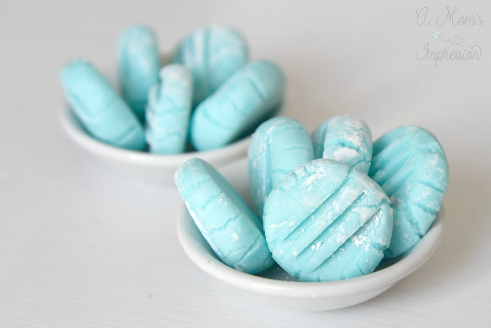 Soft blue cream cheese mints in small bowls, a classic option for homemade baby shower desserts.