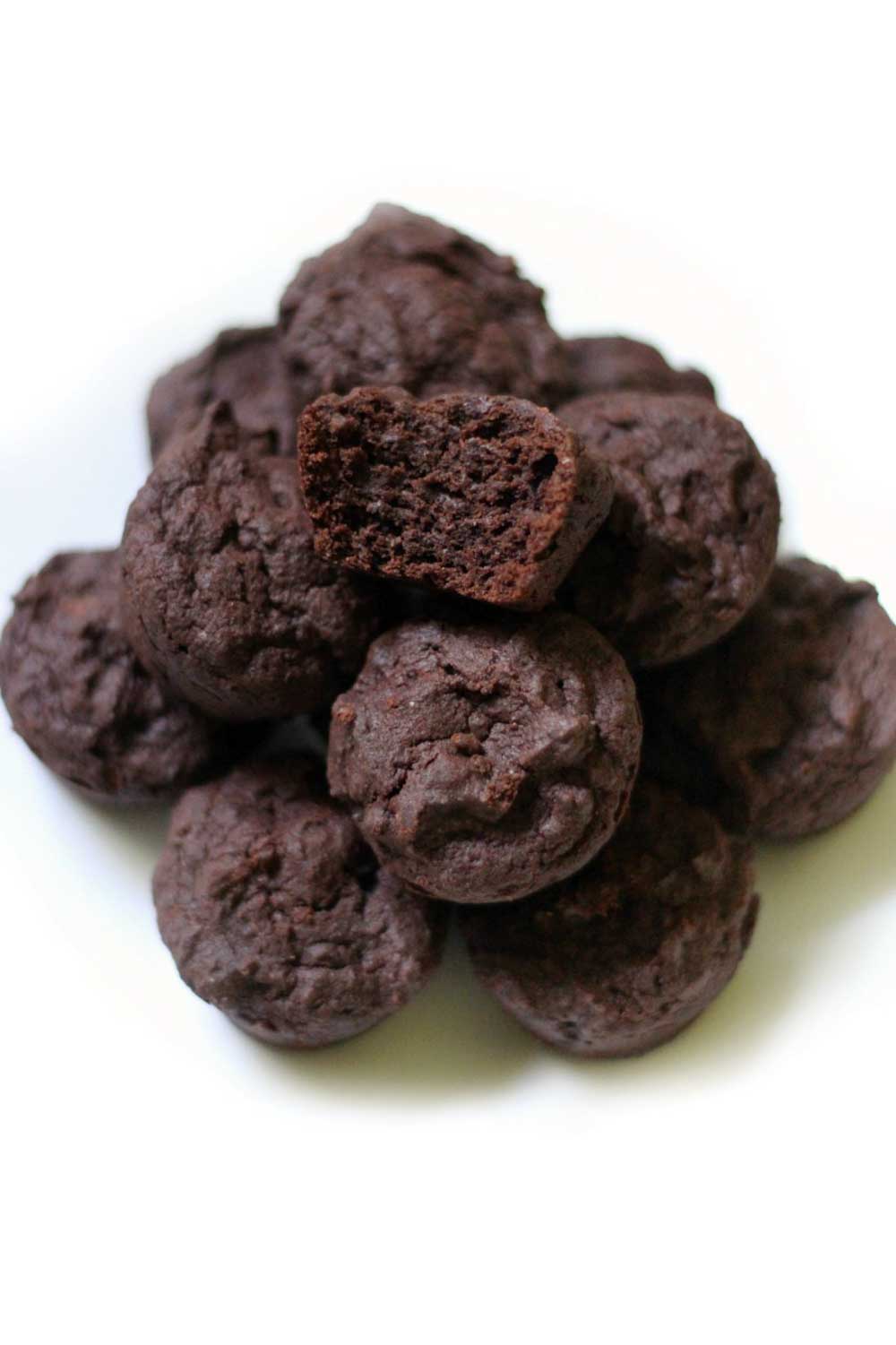 Bite-sized chocolate brownie bites stacked on a plate, rich and fudgy with a chewy texture.