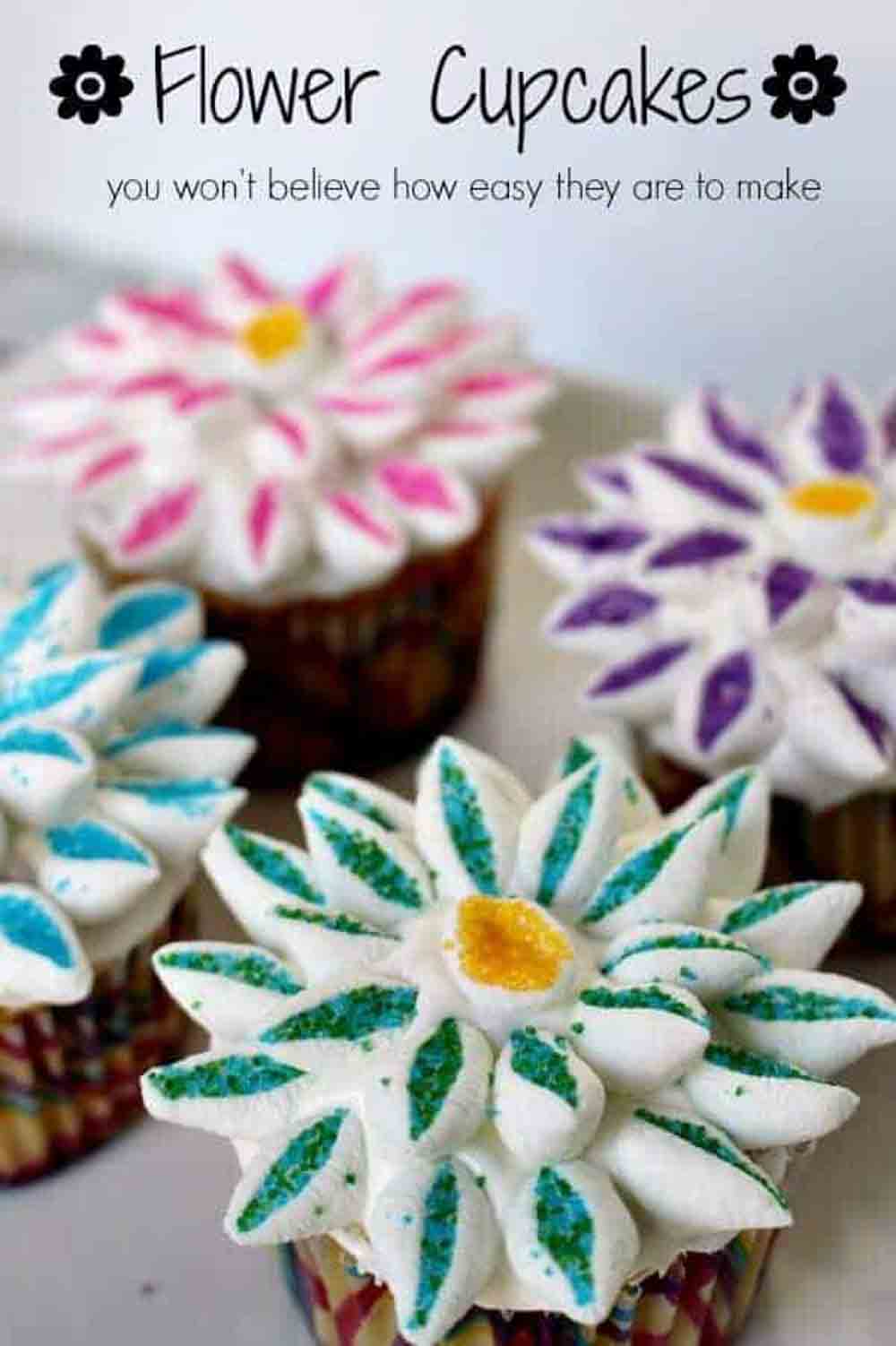 Colorful flower cupcakes decorated with piped frosting petals, a fun DIY baby shower desserts idea.