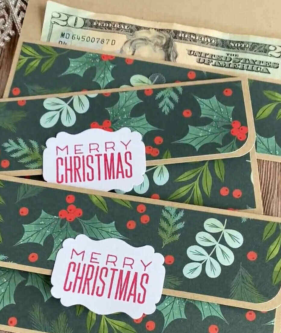 Money Envelopes with holly berry pattern and a tab closure that says Merry Christmas. a $20 bill sitting behind them.